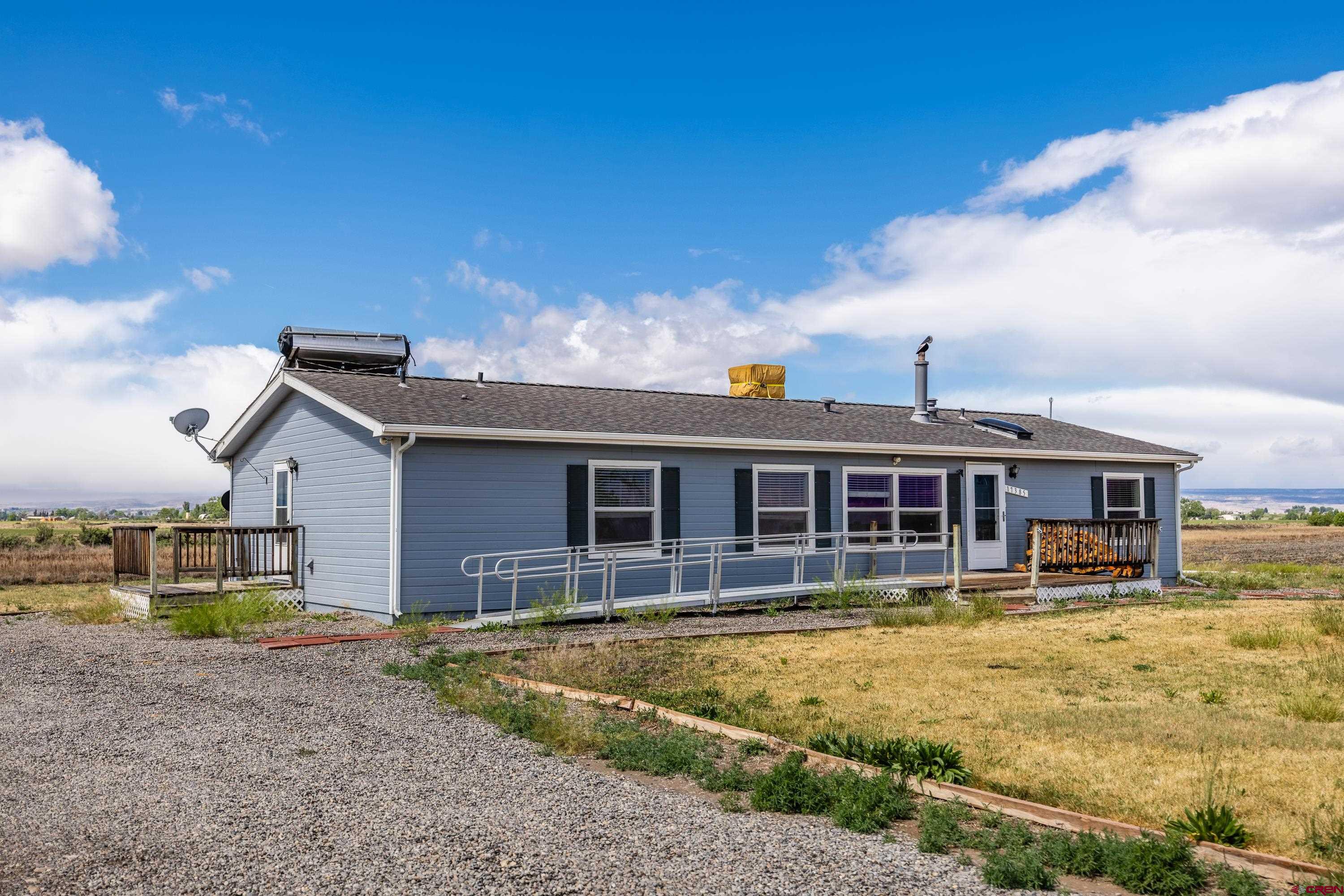 17377 Breeze Road Delta, CO 81416 - Photo 13 of 45 a front view of a house with a yard