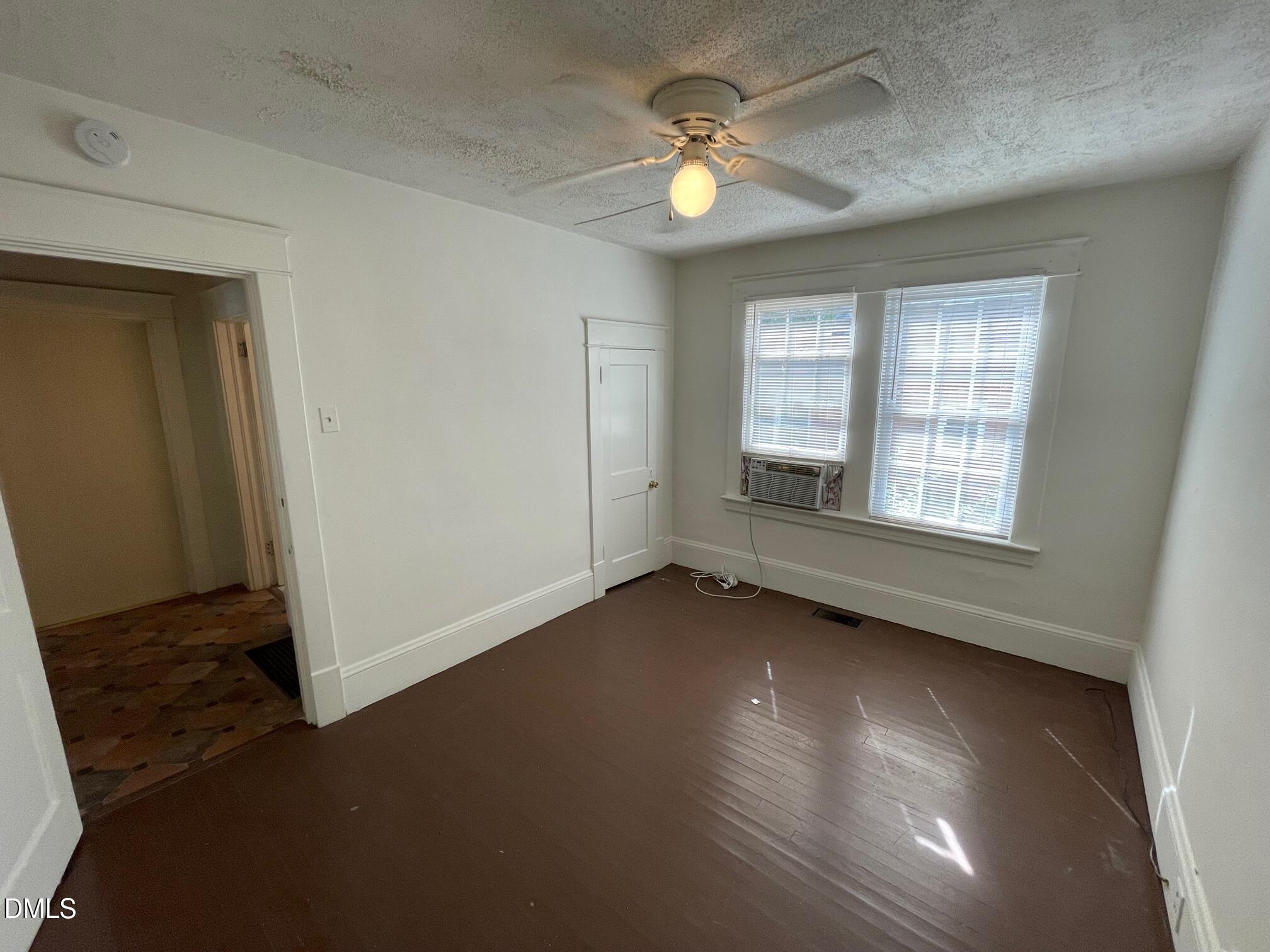 404 Chamberlain Street, Unit A Raleigh, NC 27607 - Photo 11 of 12 an empty room with wooden floor and windows