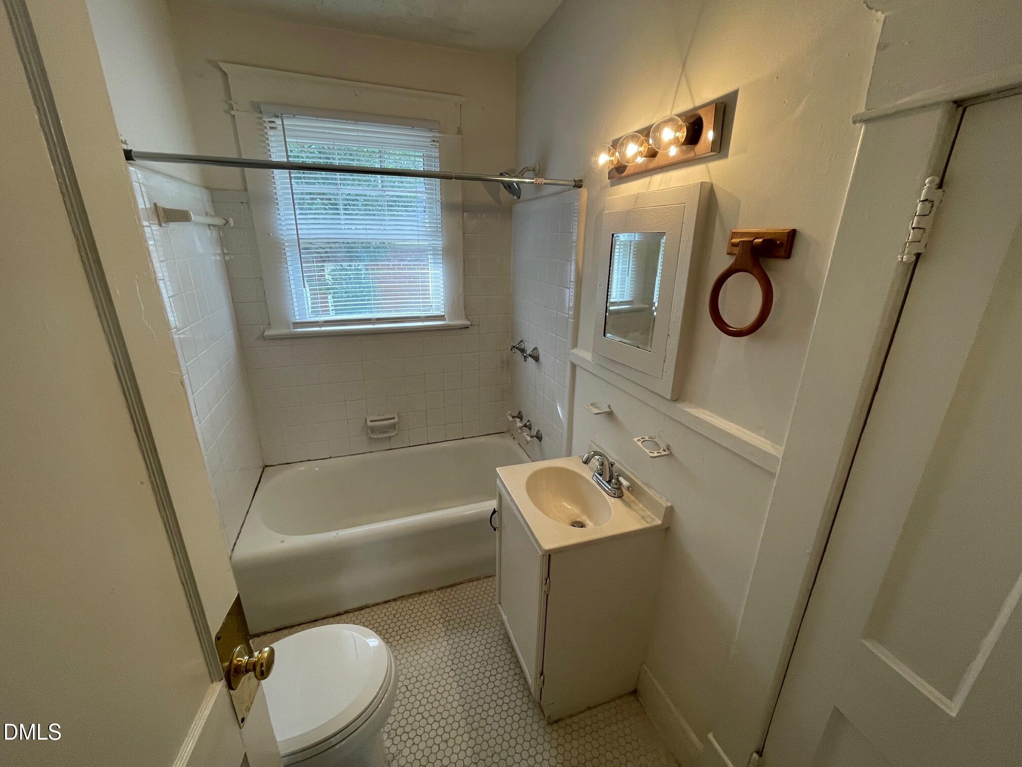 404 Chamberlain Street, Unit A Raleigh, NC 27607 - Photo 12 of 12 a bathroom with a toilet a sink and bathtub