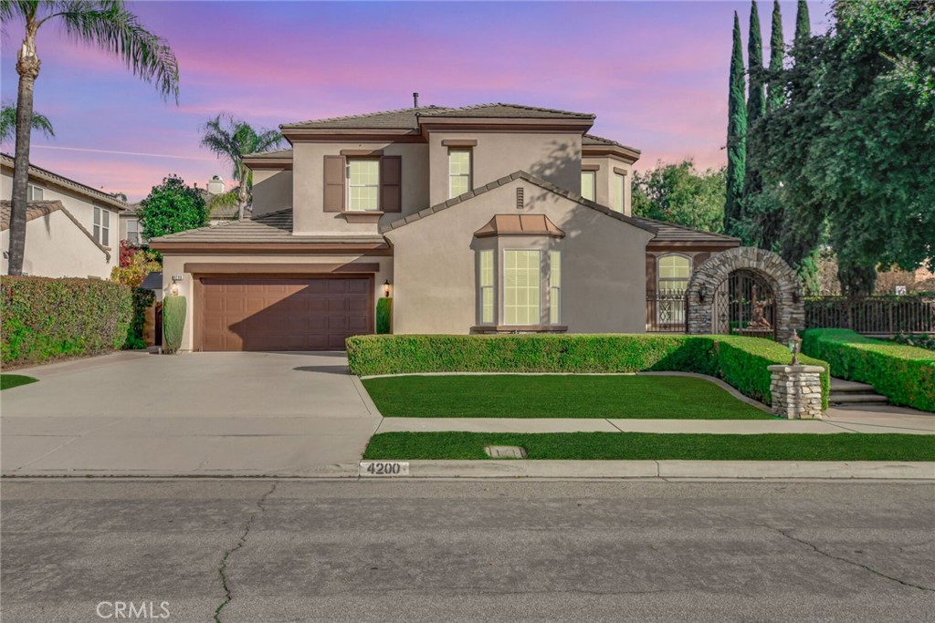 4200 Hartshorn Ranch Place La Verne, CA 91750 - Photo 1 of 1 a front view of a house with a yard and a garage
