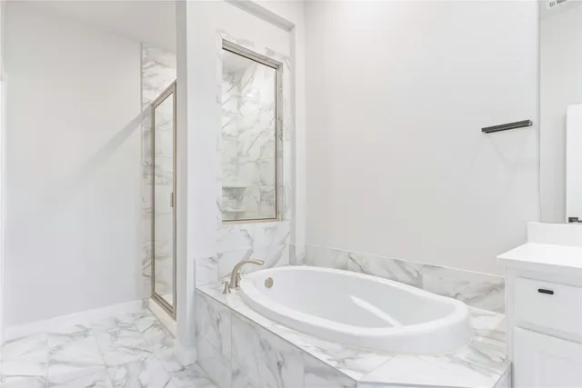 a bathroom with a tub and shower