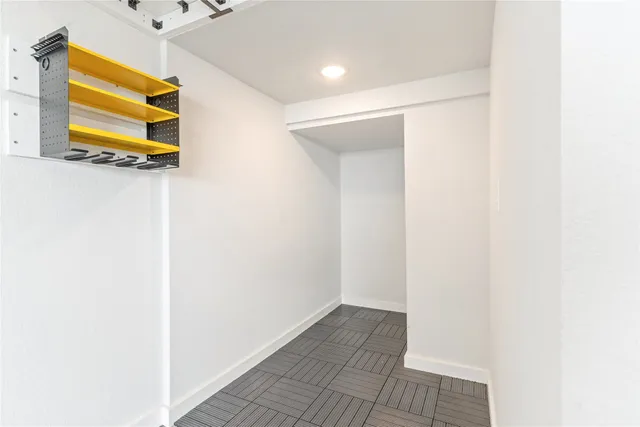 a view of a room with wooden floor