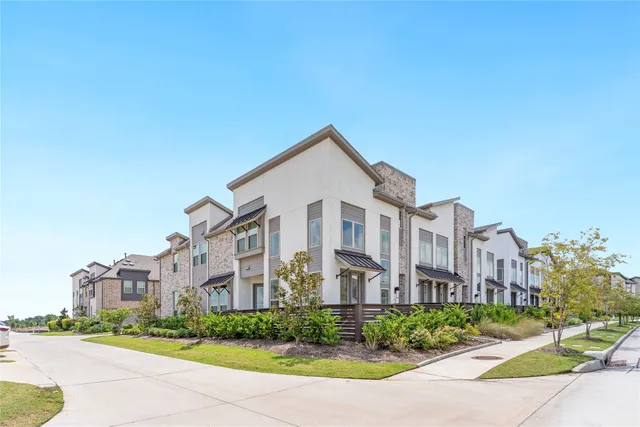 a front view of a residential apartment building with a yard