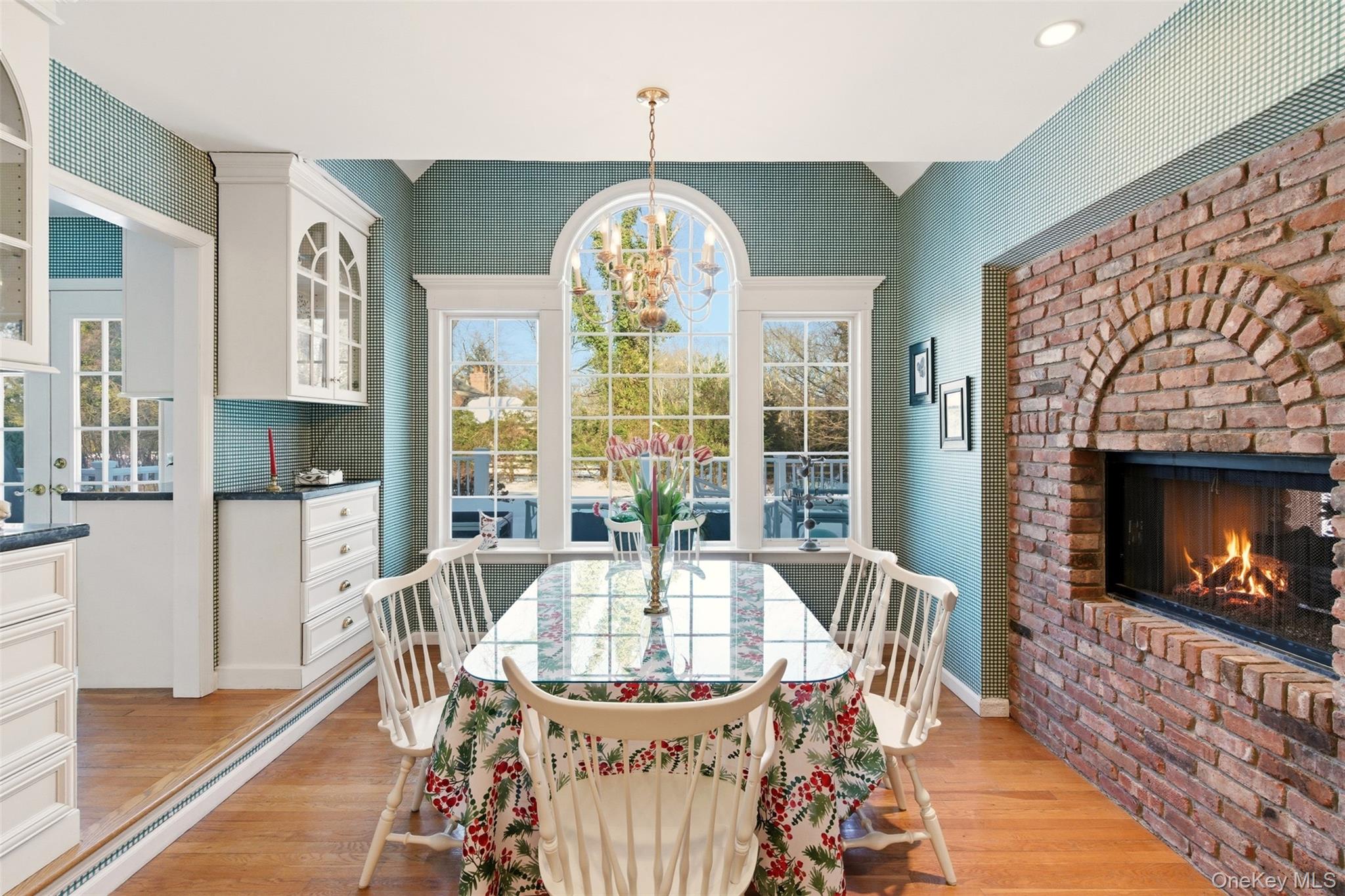 55 Titus Lane Cold Spring Harbor, NY 11724 - Photo 10 of 29 Breakfast room with large windows, built-ins and double sided fireplace