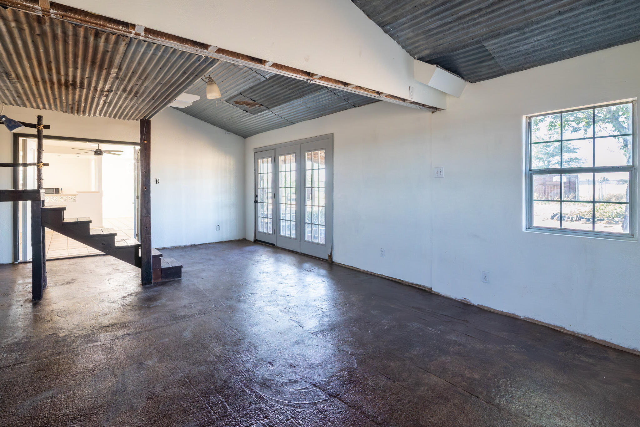 6917 Highway 114 Lubbock, TX 79407 - Photo 34 of 45 an empty room with wooden floor and windows