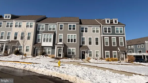 a front view of a building with a yard