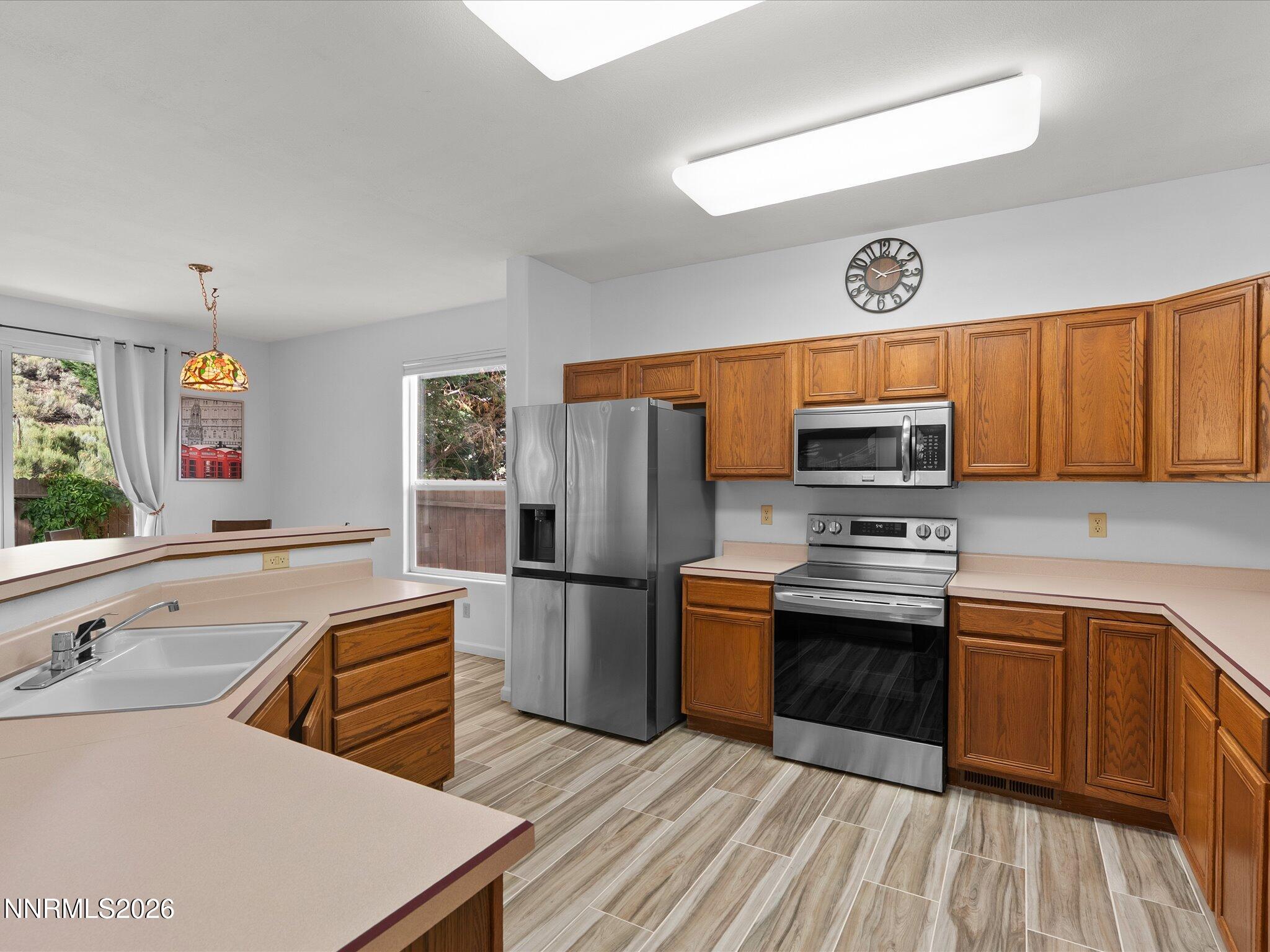 3101 Green River Drive Reno, NV 89503 - Photo 12 of 62 a kitchen with stainless steel appliances a stove refrigerator sink and microwave