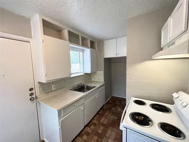 a kitchen with a stove and a refrigerator