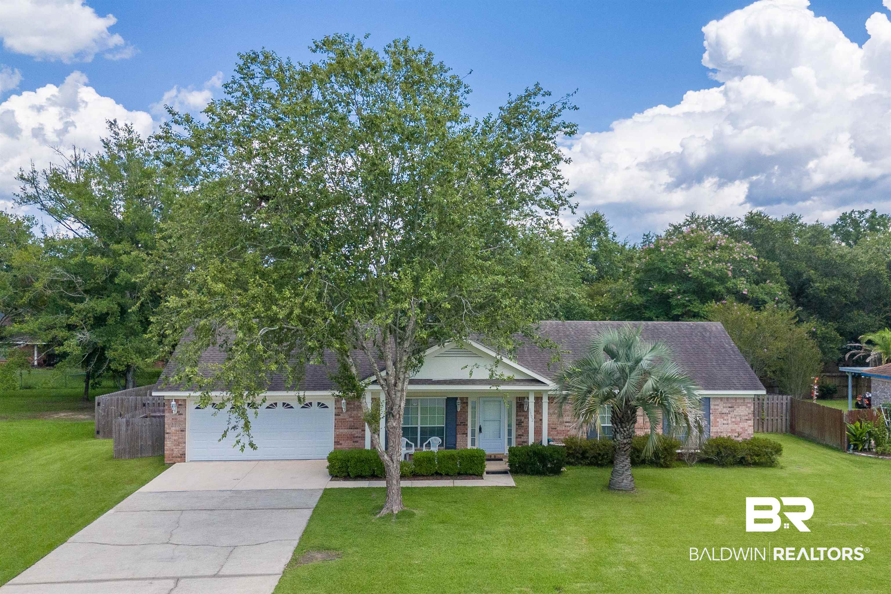 1502 Mulberry Lane Foley, AL 36535 - Photo 2 of 45 View of front of home featuring a garage and a front lawn