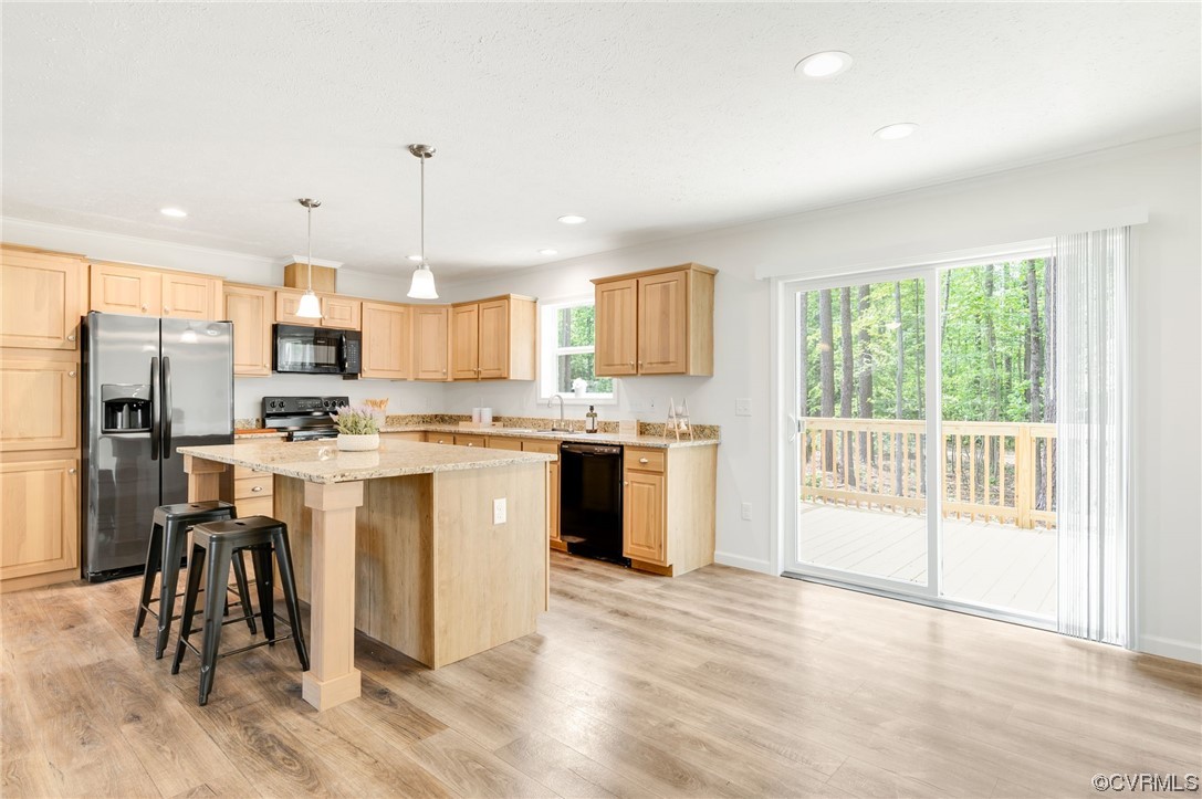 1055 Eastham Road Bumpass, VA 23024 - Photo 10 of 42 a kitchen with a refrigerator a sink dishwasher with a dining table and chairs