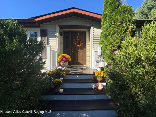 a large kitchen with cabinets chairs and wooden floor