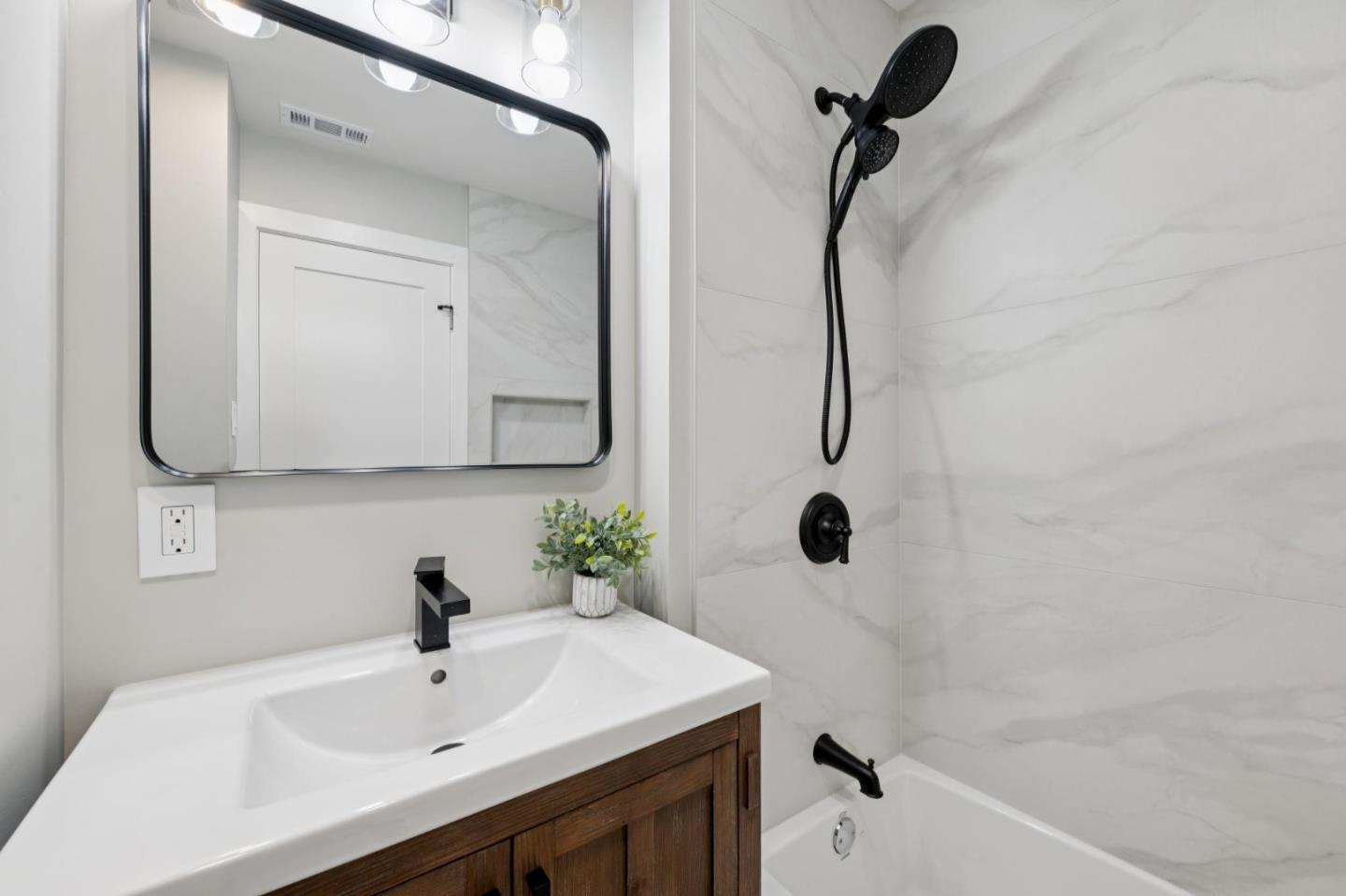 2 Celia Court Pacifica, CA 94044 - Photo 26 of 47 a bathroom with a sink and mirror with bathtub