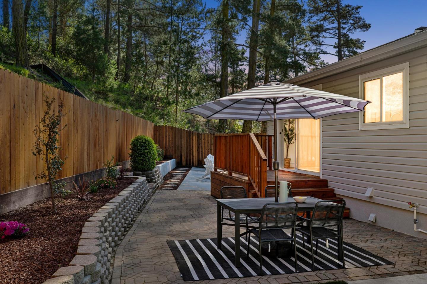 2 Celia Court Pacifica, CA 94044 - Photo 41 of 47 a view of a patio with table and chairs under an umbrella with wooden fence
