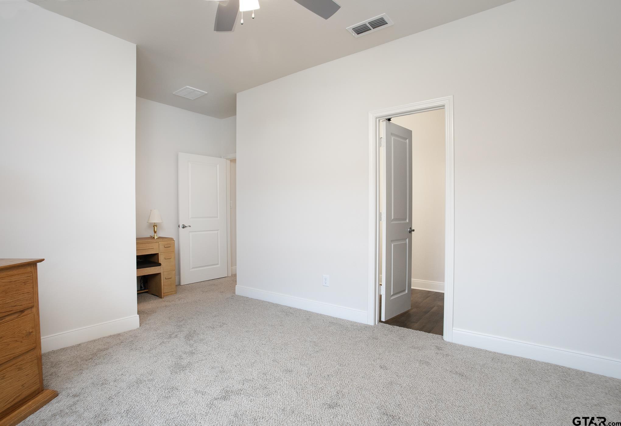 6143 Hamilton Mdws Way Tyler, TX 75703 - Photo 12 of 29 an empty room with fireplace and closet