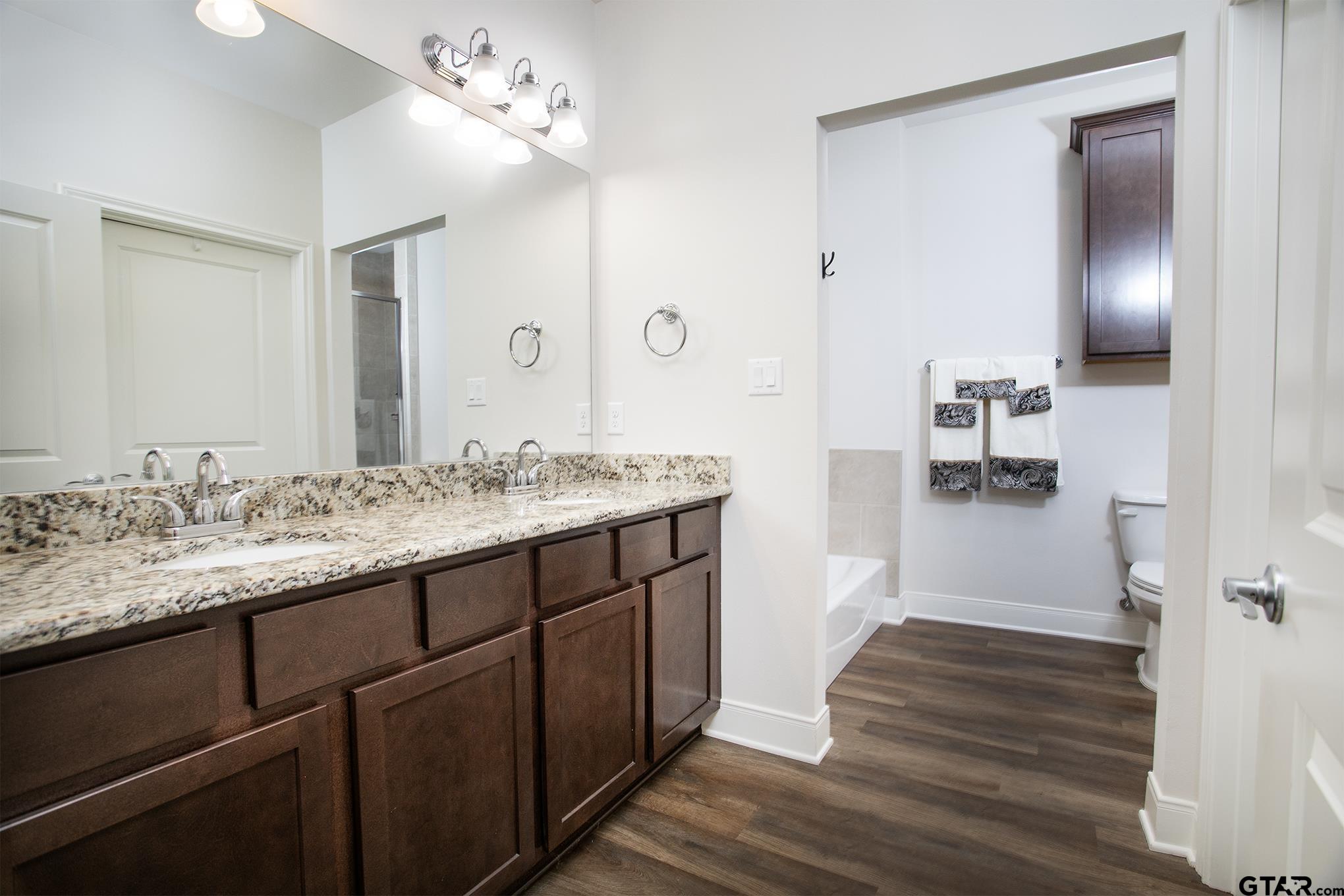 6143 Hamilton Mdws Way Tyler, TX 75703 - Photo 14 of 29 a bathroom with a sink double vanity and a mirror