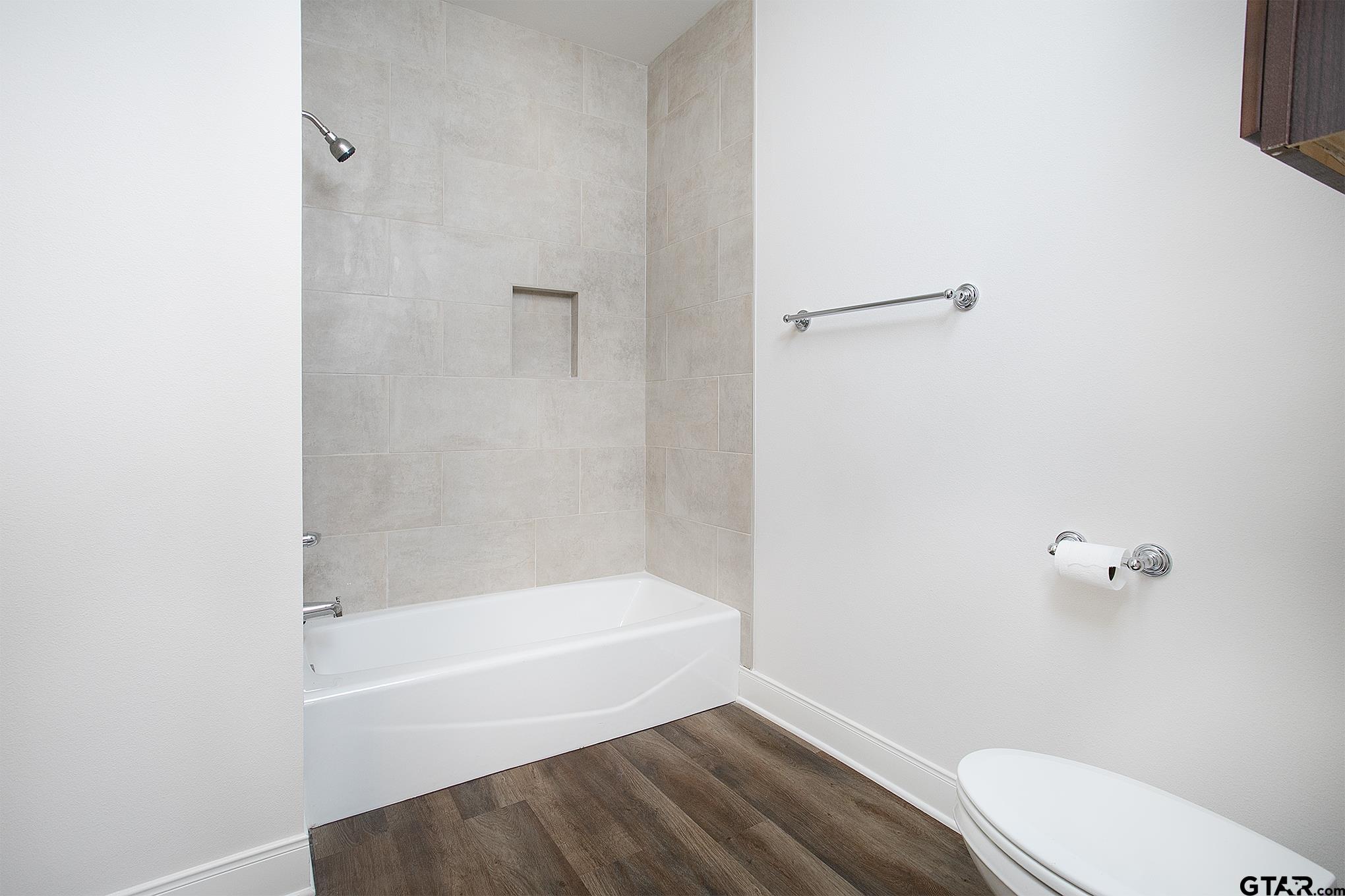 6143 Hamilton Mdws Way Tyler, TX 75703 - Photo 15 of 29 a bathroom with a bathtub and shower