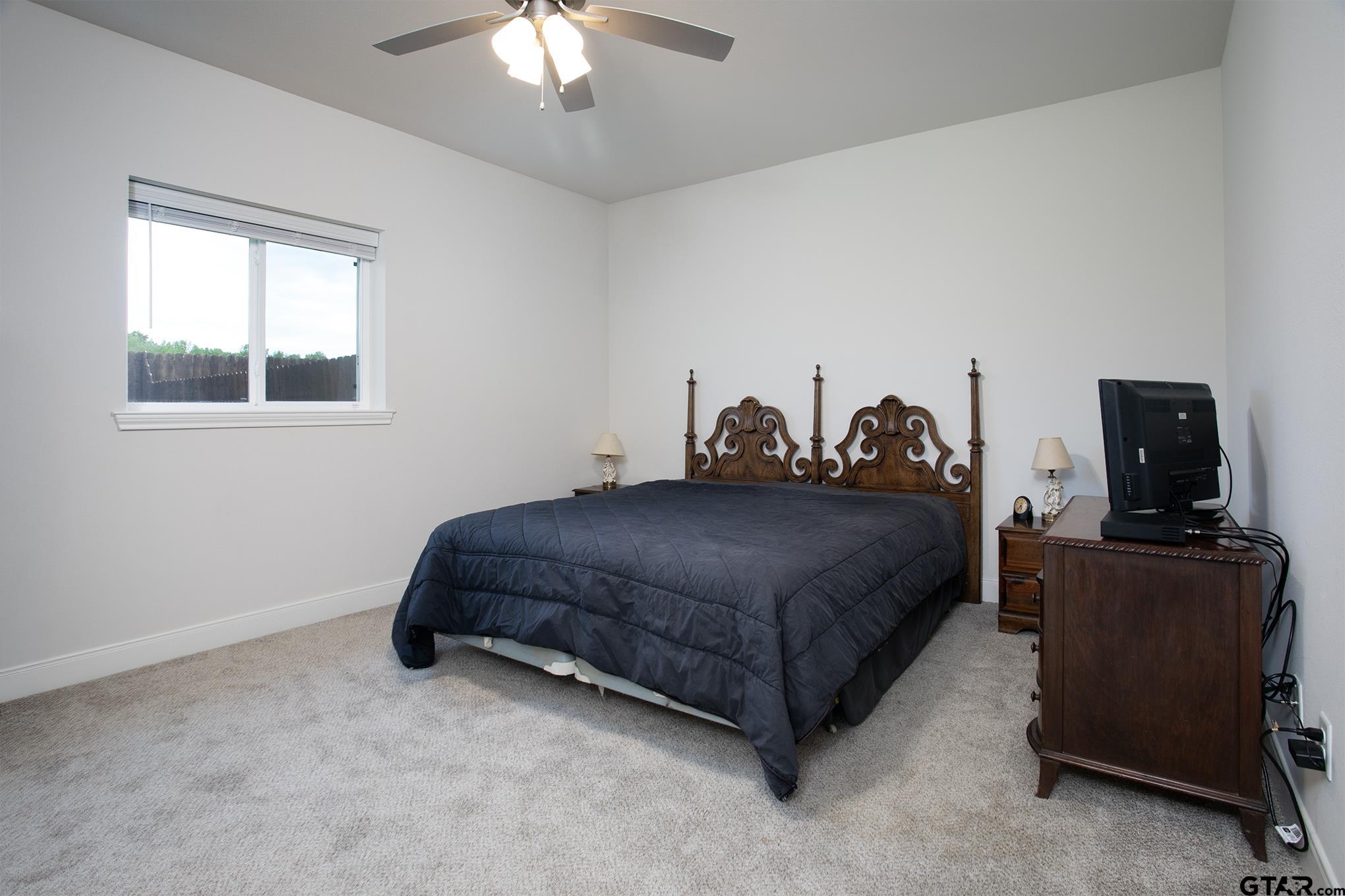 6143 Hamilton Mdws Way Tyler, TX 75703 - Photo 18 of 29 a bedroom with a bed and a television