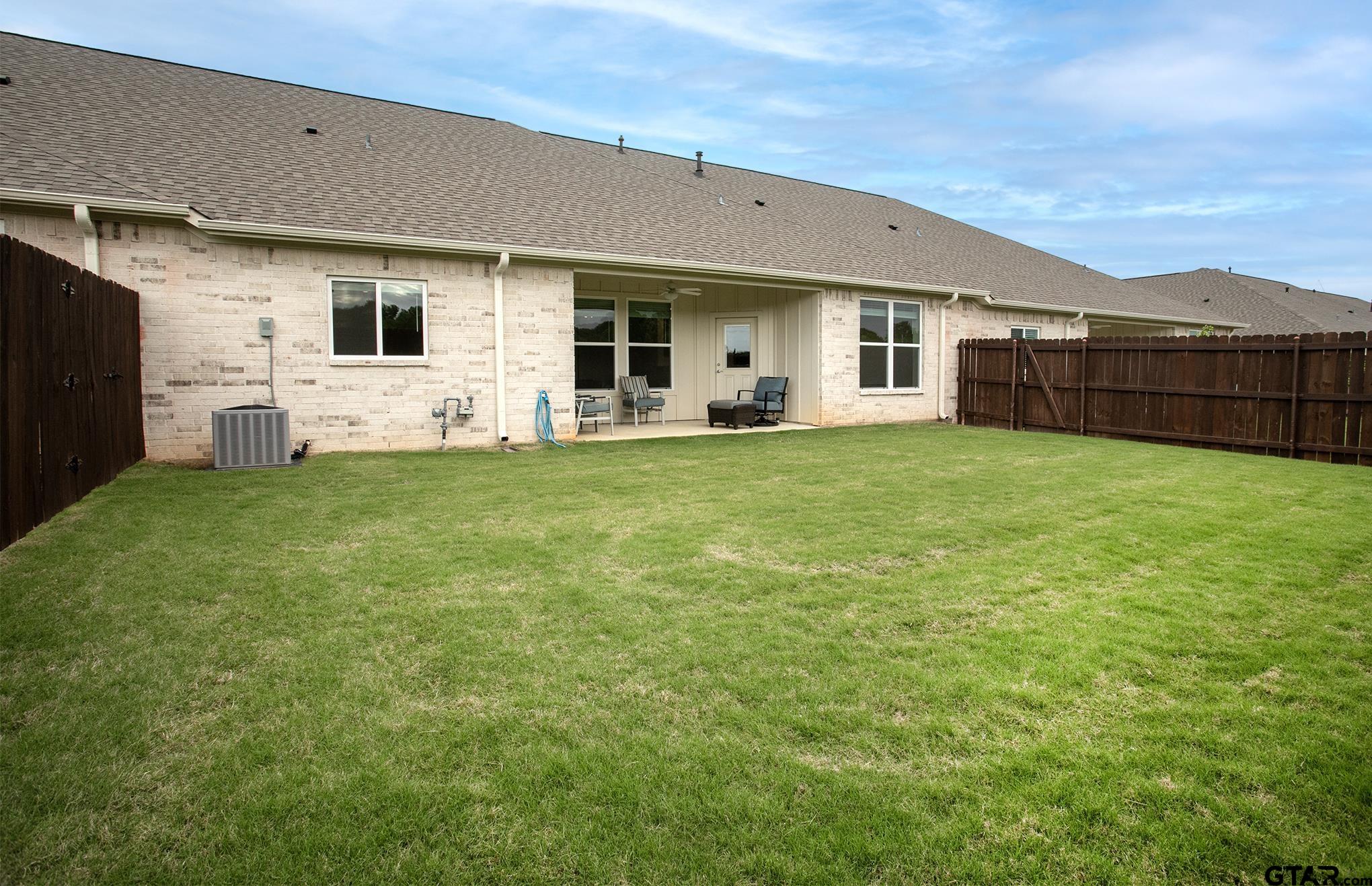 6143 Hamilton Mdws Way Tyler, TX 75703 - Photo 20 of 29 a view of a house with a backyard and porch