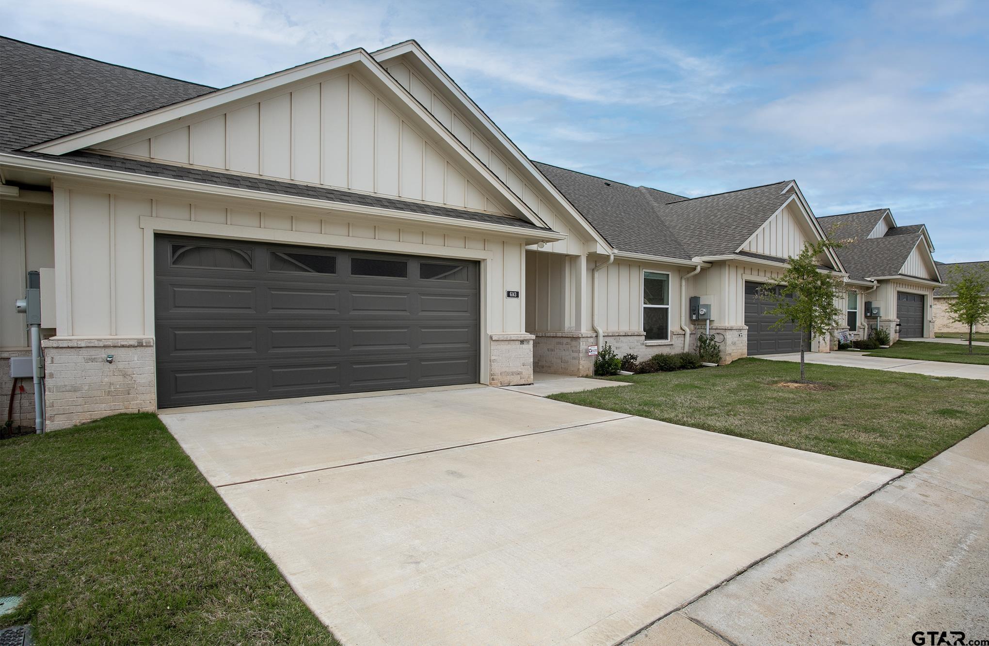 6143 Hamilton Mdws Way Tyler, TX 75703 - Photo 23 of 29 a front view of a house with a yard and garage