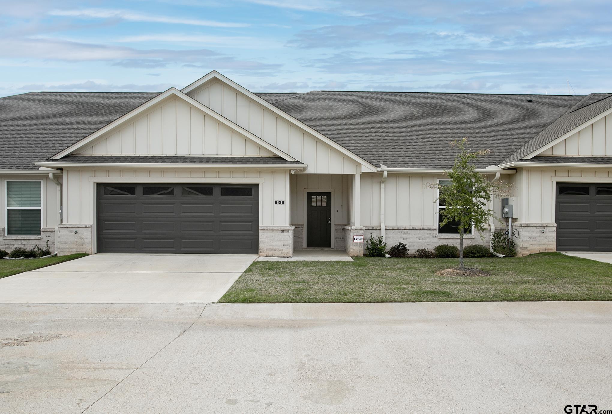 6143 Hamilton Mdws Way Tyler, TX 75703 - Photo 24 of 29 a front view of a house with a yard and garage