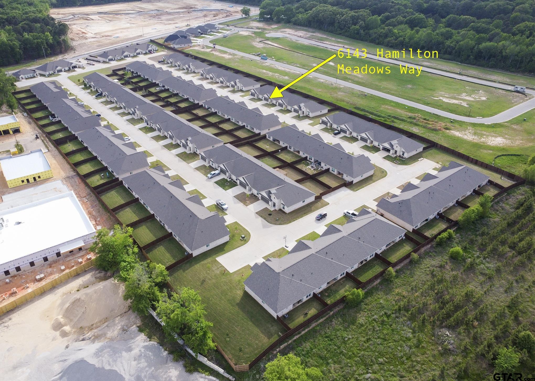 6143 Hamilton Mdws Way Tyler, TX 75703 - Photo 26 of 29 an aerial view of a tennis ground with a large pool