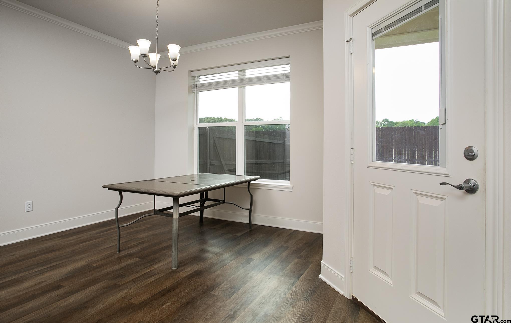 6143 Hamilton Mdws Way Tyler, TX 75703 - Photo 8 of 29 a view of a room with wooden floor fan and windows