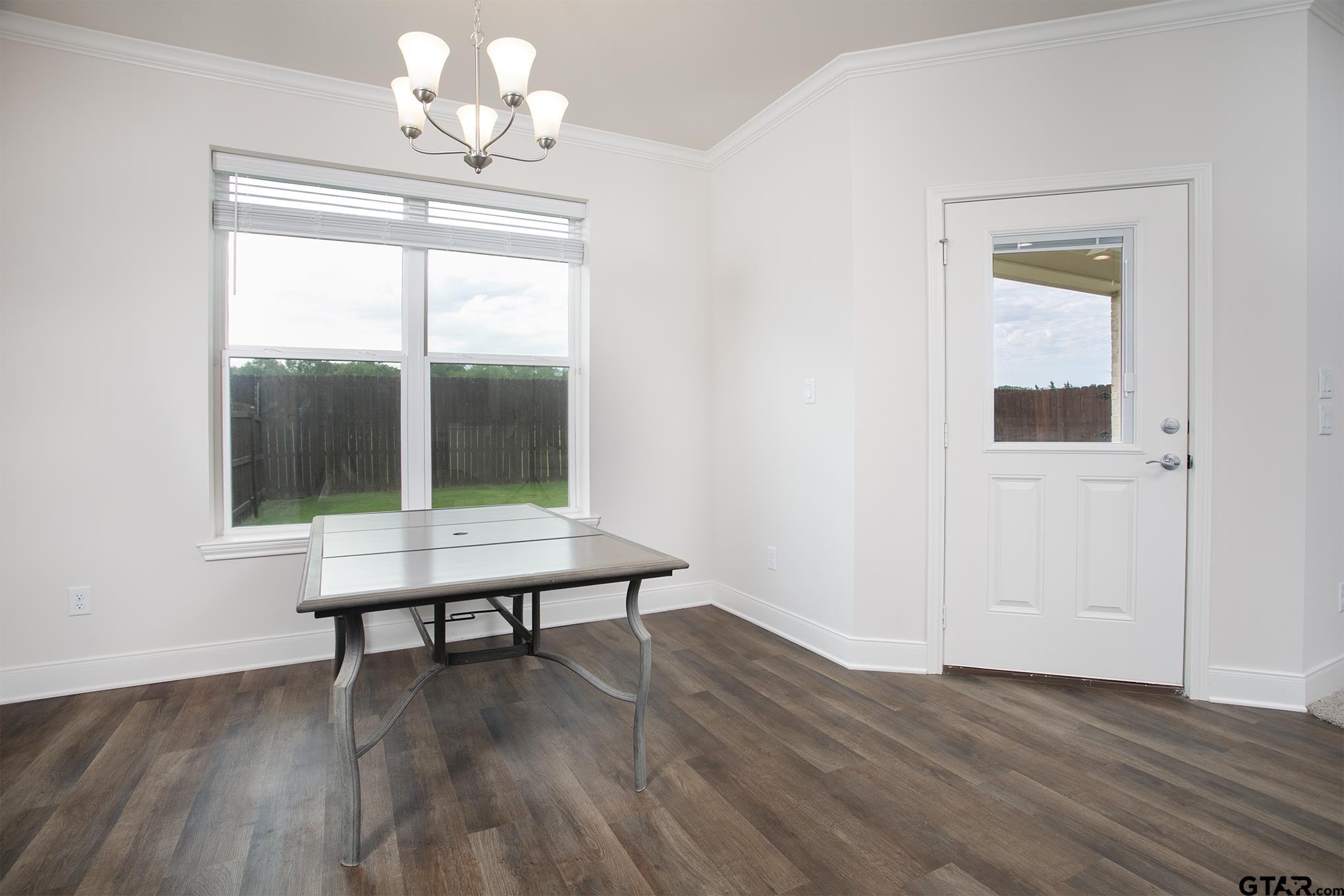 6143 Hamilton Mdws Way Tyler, TX 75703 - Photo 9 of 29 a view of a room with wooden floor fan and windows