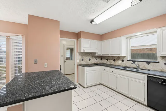 a kitchen with sink cabinets and window