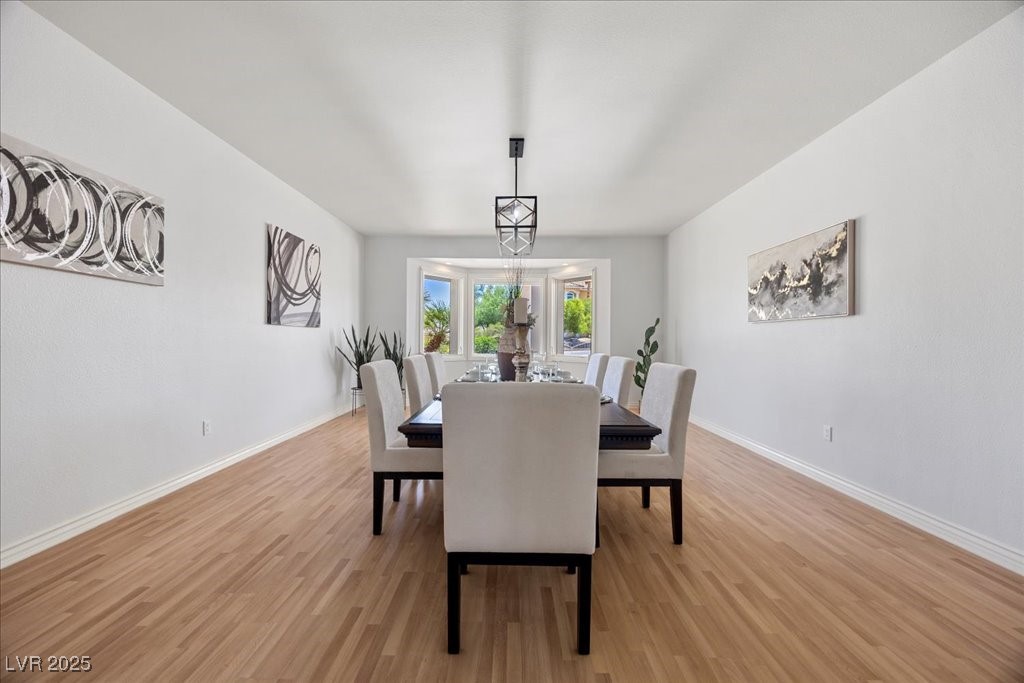 640 Quail Covey Road Henderson, NV 89002 - Photo 20 of 75 Formal Dining room with Pergo wood-style flooring and baseboards