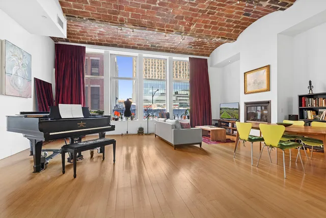 a living room with furniture and floor to ceiling windows