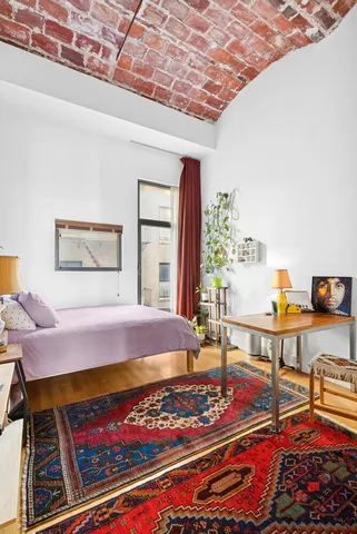 a bed room with a bed and a table