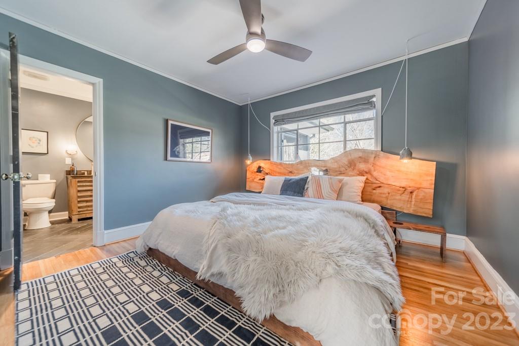 1011 Scaleybark Road Charlotte, NC 28209 - Photo 13 of 40 a bedroom with a bed and wooden floor