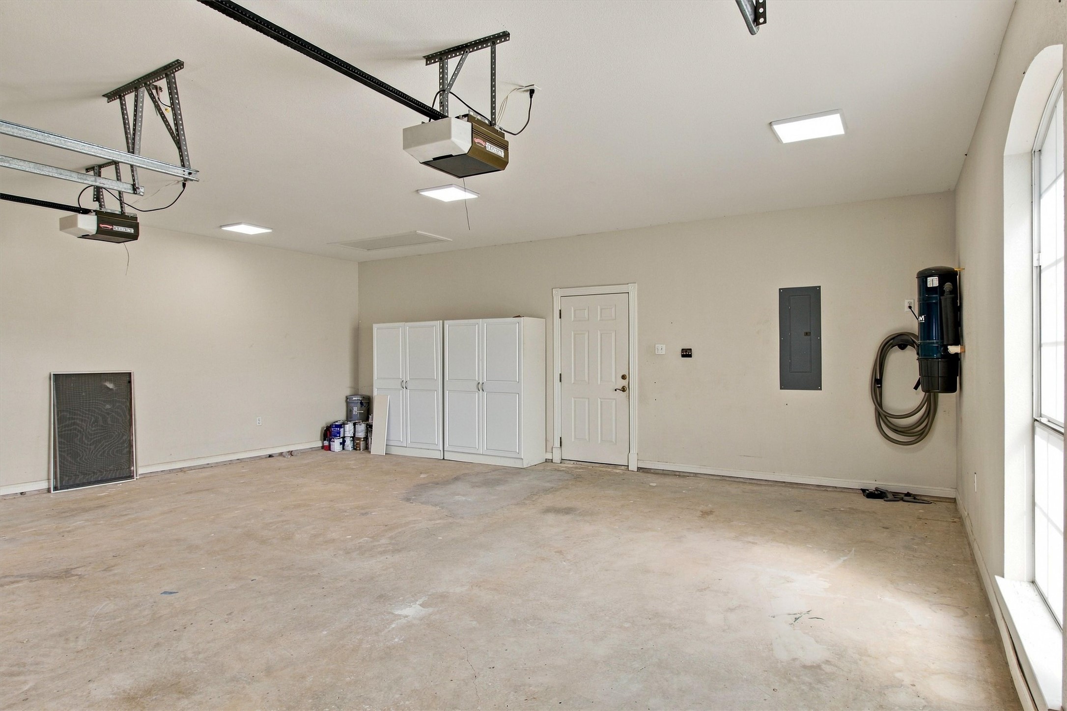 1651 Old Red Ranch Road Dripping Springs, TX 78620 - Photo 25 of 31 An accommodating garage features concrete flooring, built-in storage cabinets, and a side access door.