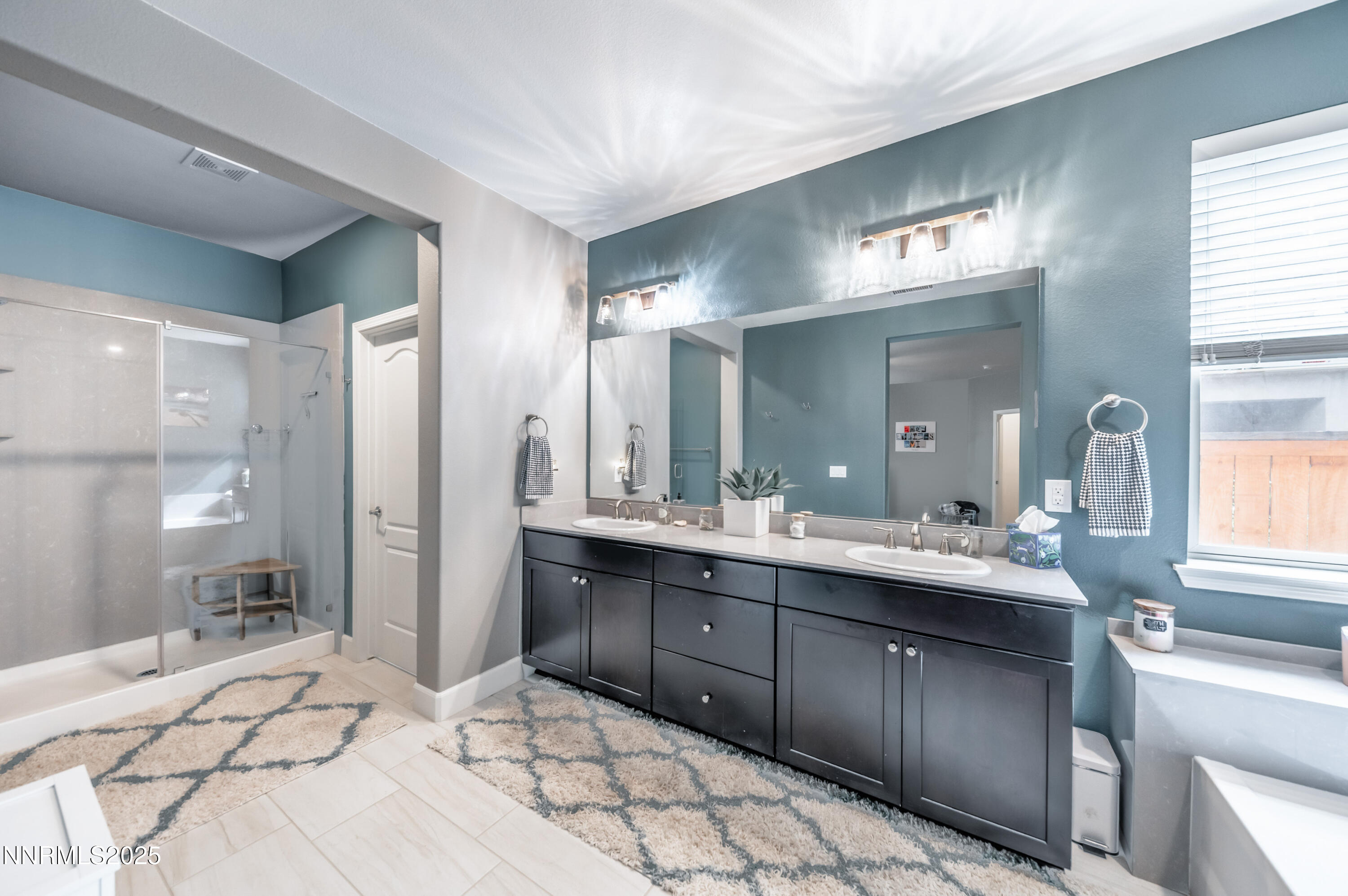 1640 Scott Valley Road Reno, NV 89523 - Photo 14 of 25 a large bathroom with a sink mirror and shower