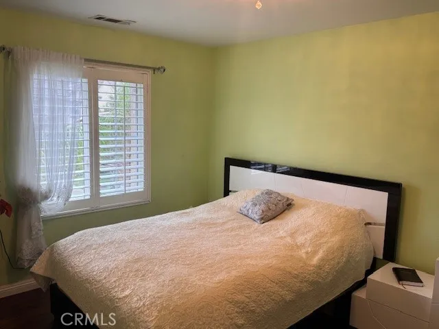a bedroom with a bed and window