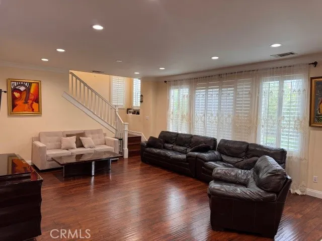 a living room with furniture and wooden floor
