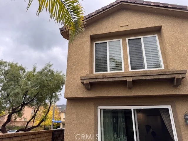 a house that has a tree in front of the house