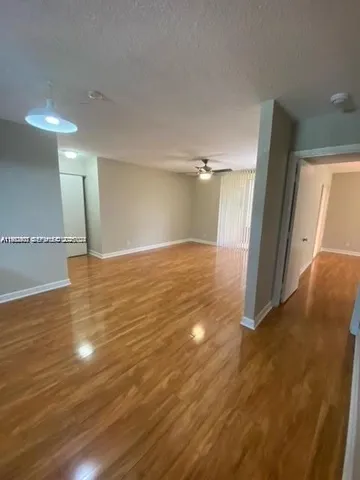 a view of a room with wooden floor
