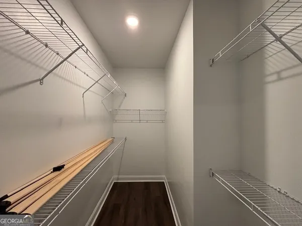 a kitchen with a refrigerator a sink dishwasher a stove and white cabinets with wooden floor