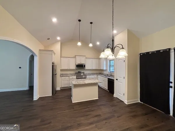 a kitchen with refrigerator and microwave