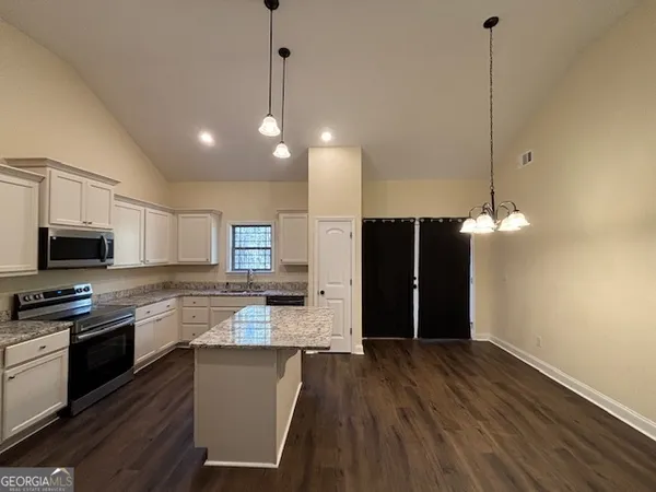 a kitchen with a stove and a microwave