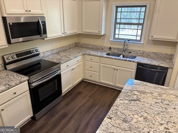 a kitchen with kitchen island stainless steel appliances a refrigerator and microwave