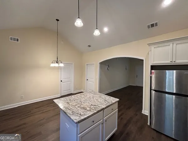 a view of empty room with wooden floor and ceiling fan