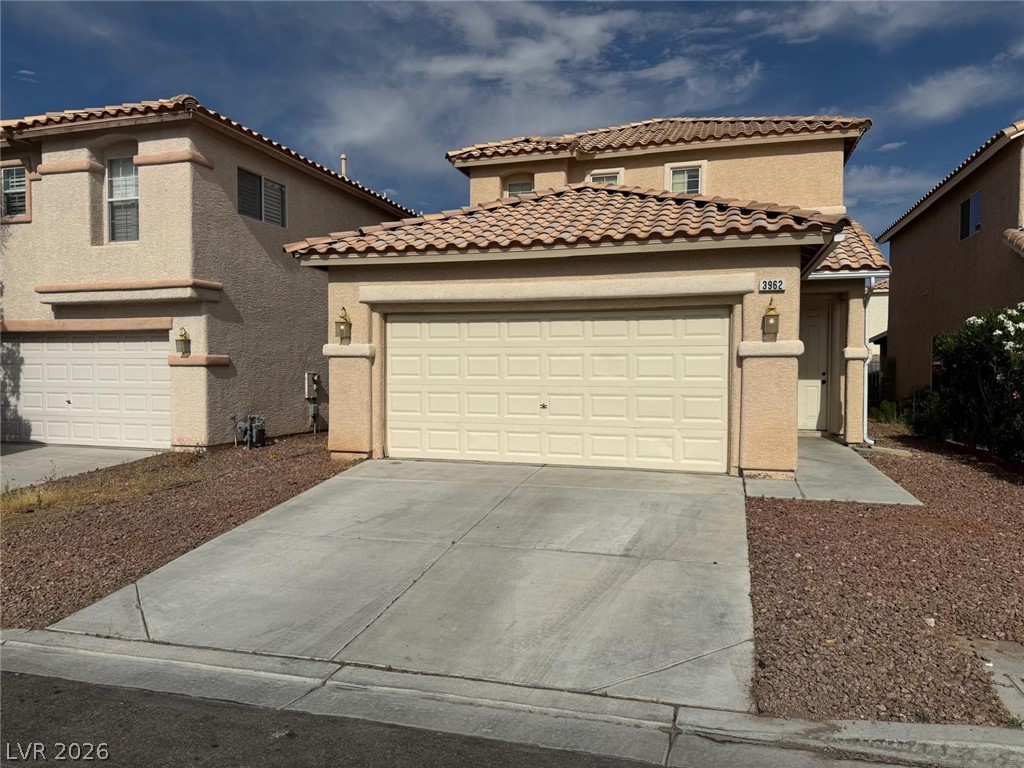 3962 Coyote Ridge Court Las Vegas, NV 89129 - Photo 1 of 35 A terracotta-tiled roof crowns this residence, featuring an attached garage and a neatly maintained desert-landscaped front yard.