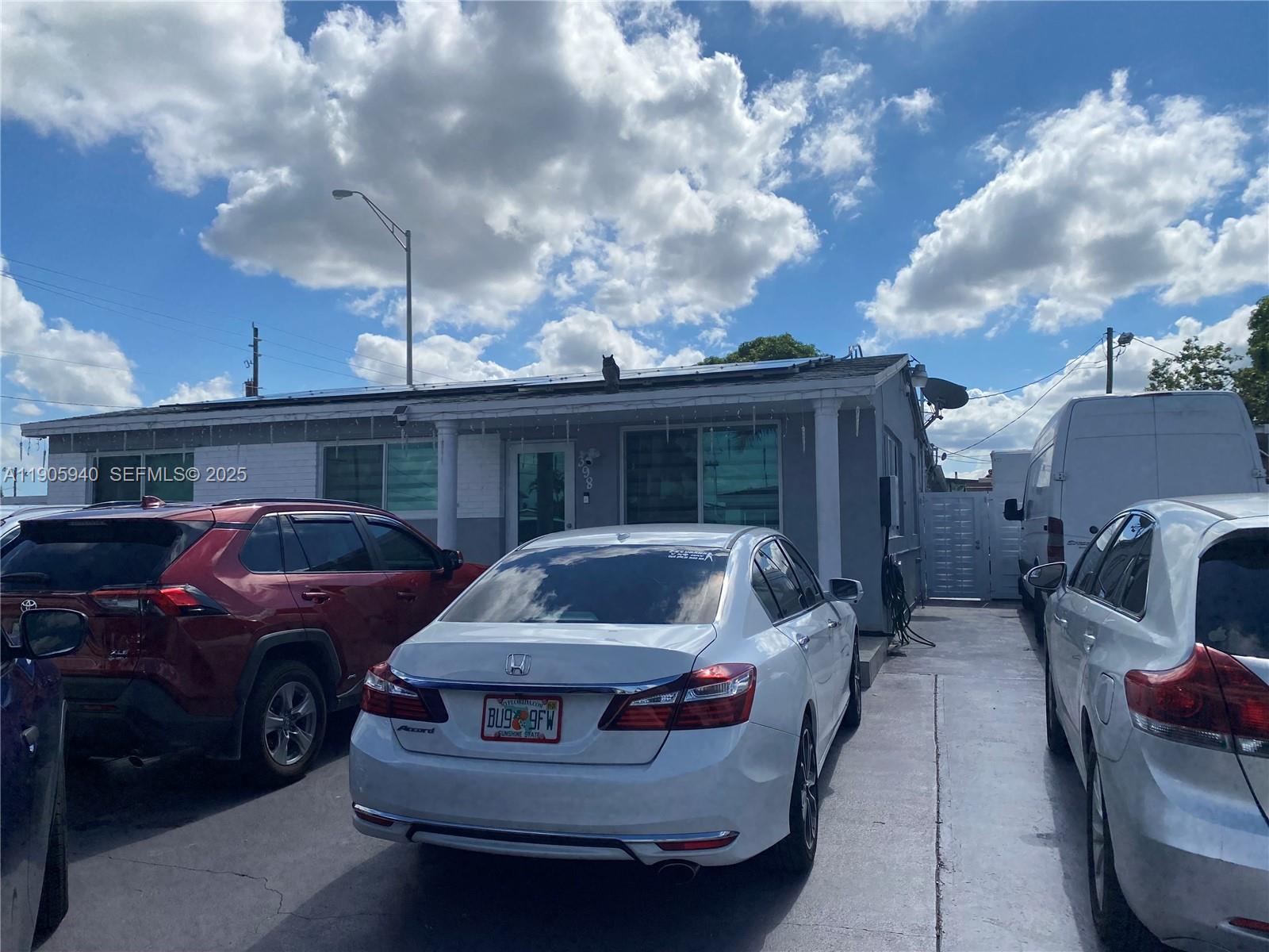 398 East 56th Street Hialeah, FL 33013 - Photo 2 of 9 a car parked in front of a house