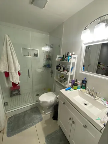 a bathroom with a sink toilet and shower