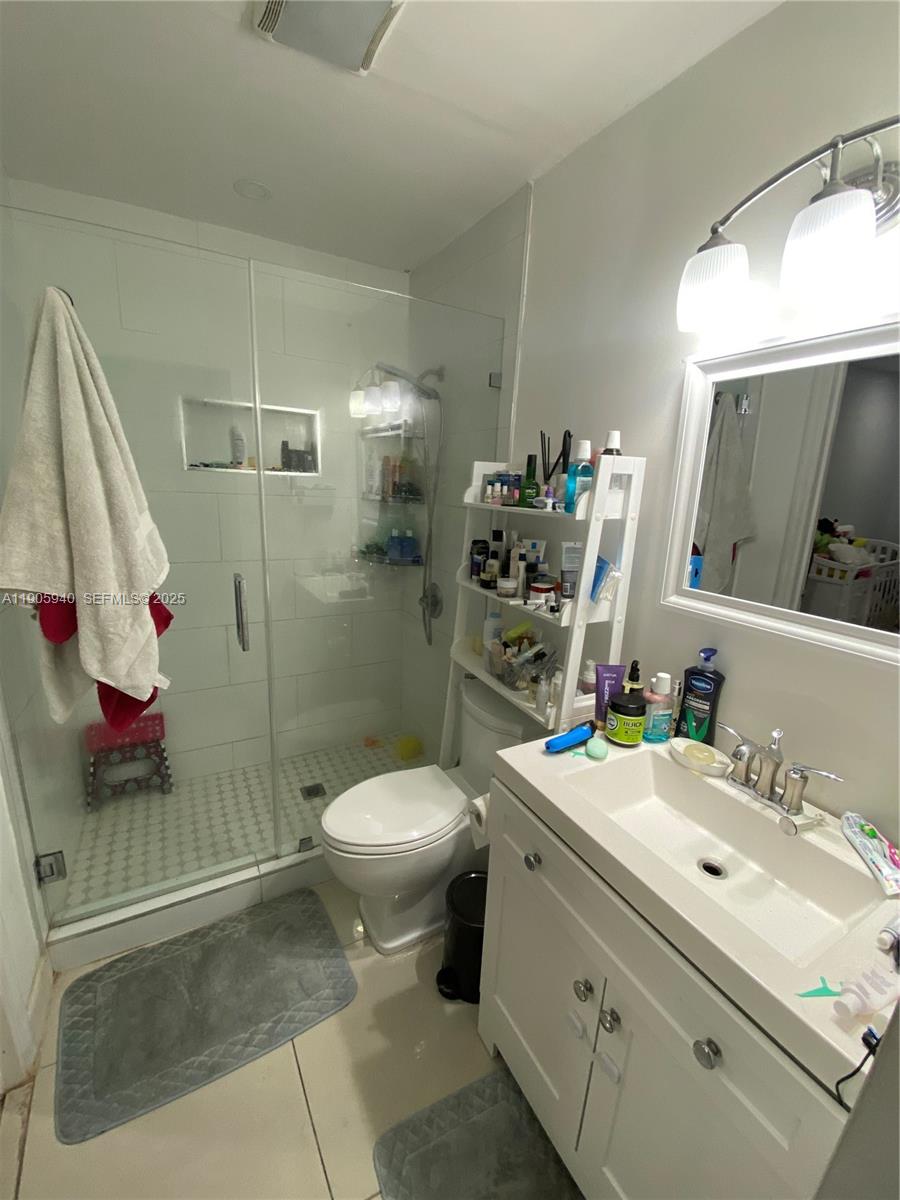 398 East 56th Street Hialeah, FL 33013 - Photo 6 of 9 a bathroom with a sink toilet and shower