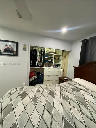 a bed room with a bed and a television