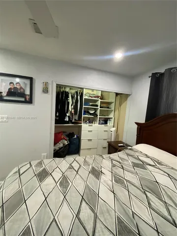 a bed room with a bed and a television