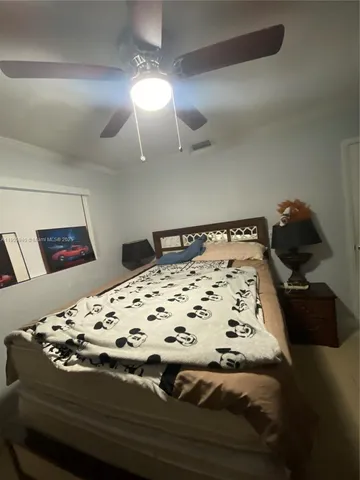 a bedroom with a bed and lamp